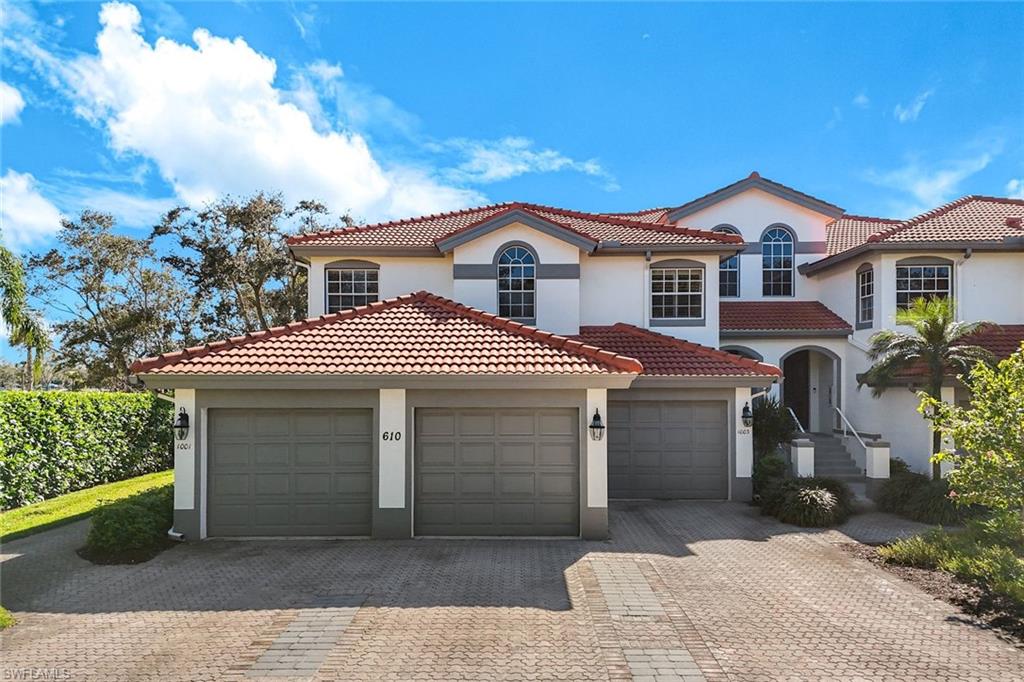 Mediterranean / spanish-style home featuring stucco siding, driveway, a garage, and a tiled roof