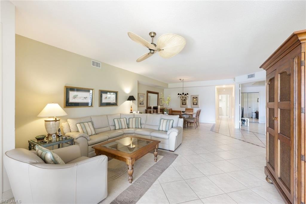 Living room with ceiling fan and light tile patterned floors