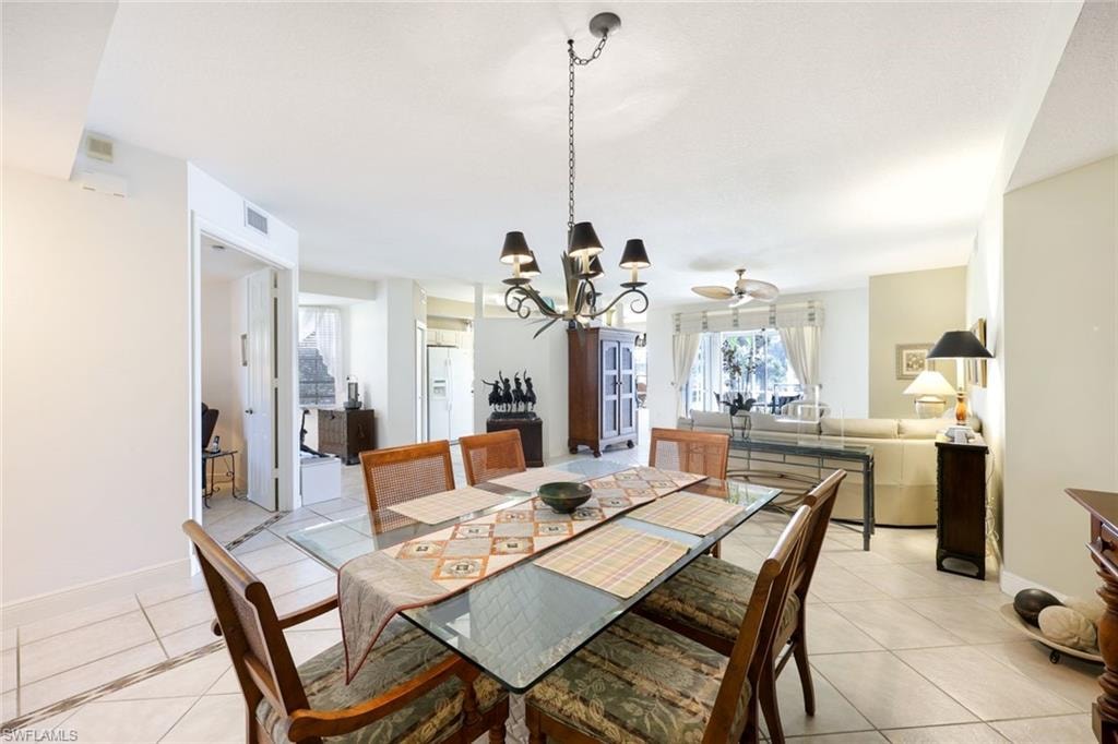 Dining room with a chandelier and light tile patterned flooring