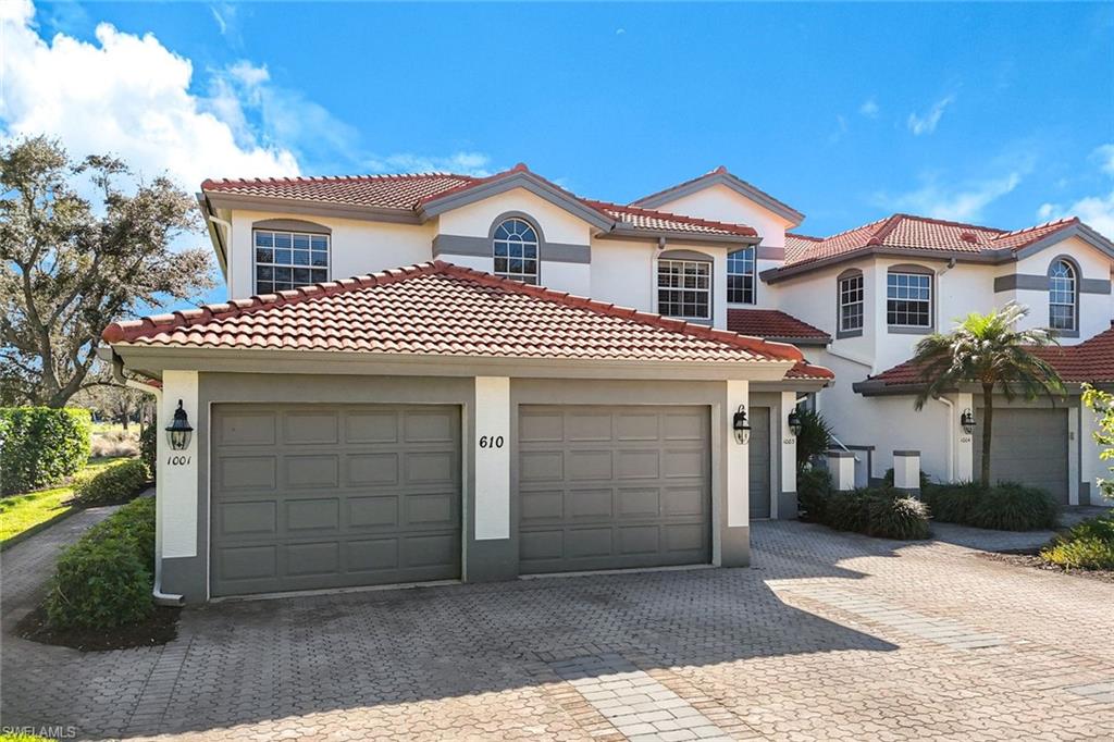 Mediterranean / spanish house featuring stucco siding, decorative driveway, a garage, and a tiled roof