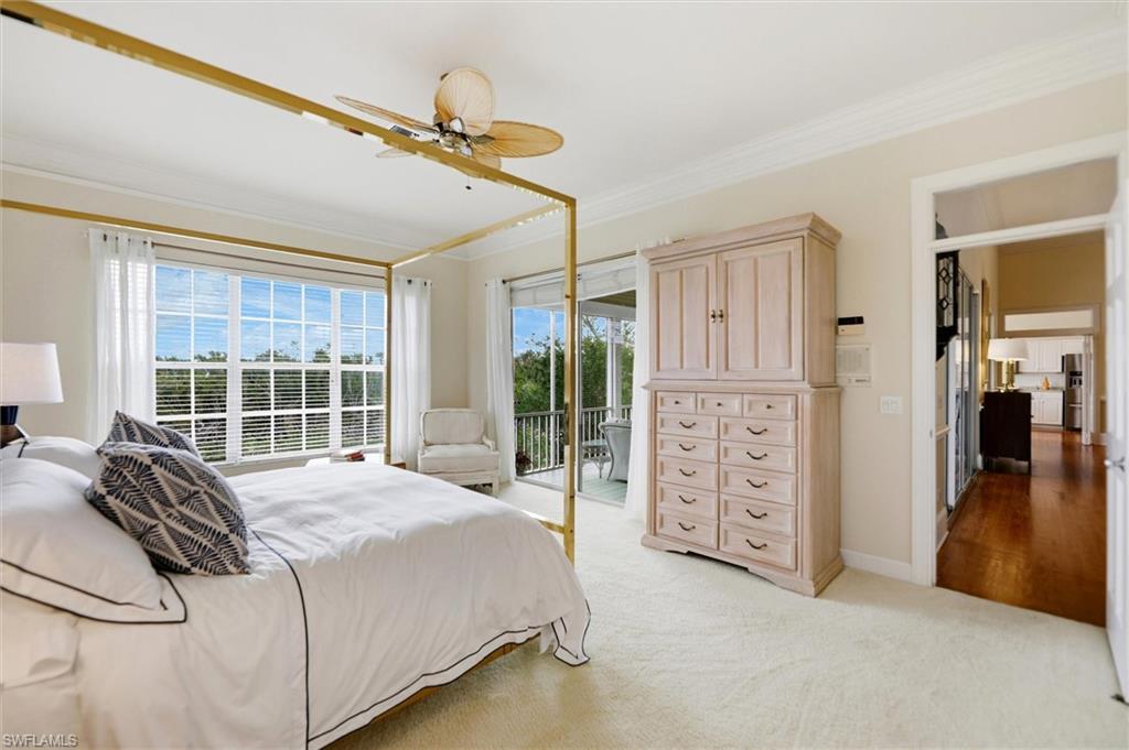 Bedroom featuring ornamental molding, light carpet, access to exterior, ceiling fan, and stainless steel refrigerator with ice dispenser