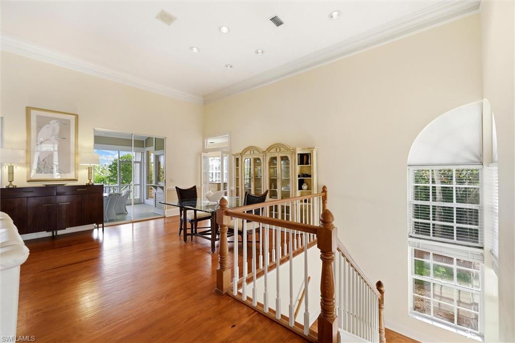 Hall featuring an upstairs landing, crown molding, and light wood-style floors