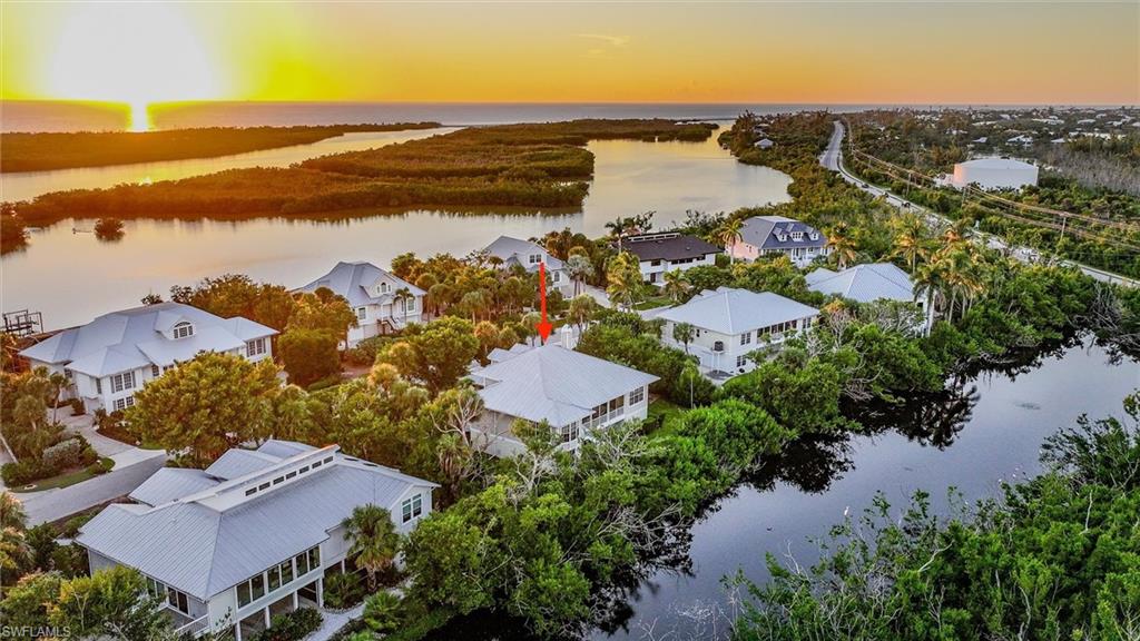 Aerial view at dusk of a water view and a residential view