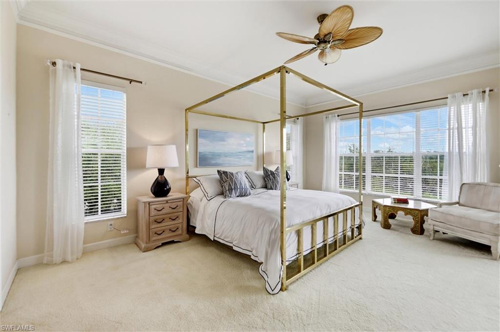 Bedroom with carpet, ornamental molding, and a ceiling fan