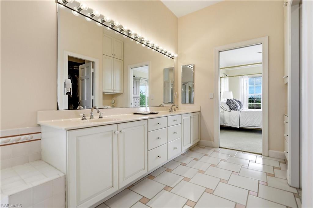 Ensuite bathroom with double vanity and baseboards