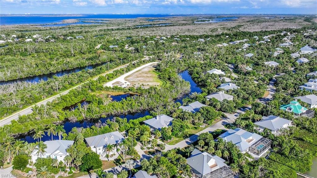 Aerial view of residential area featuring a nearby body of water