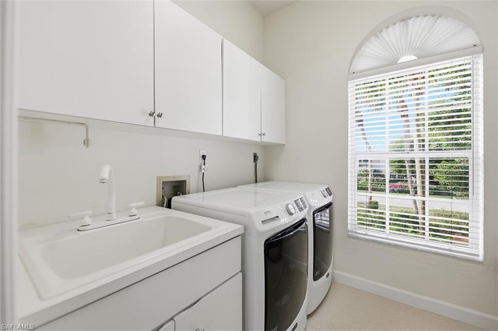 Laundry room featuring cabinet space and washing machine and clothes dryer