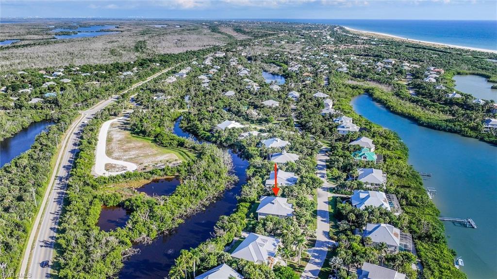 Aerial overview of property's location with a nearby body of water
