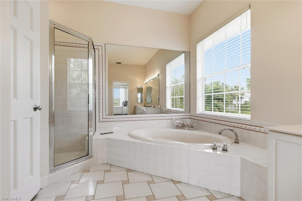 Full bathroom with a bath, a shower stall, and vanity