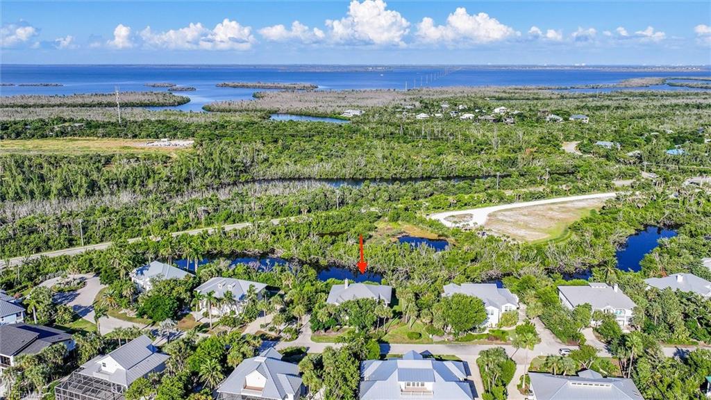 View of property location with a nearby body of water and nearby suburban area