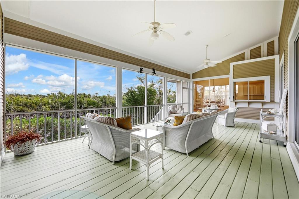 Sunroom / solarium with an outdoor living space, a ceiling fan, vaulted ceiling, and a deck
