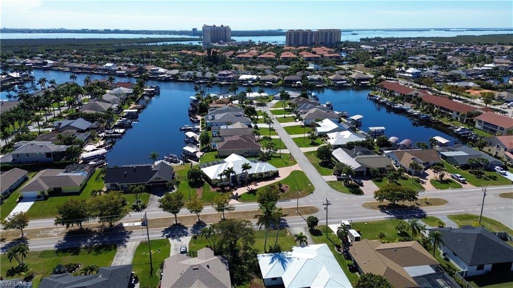 Aerial view of property's location with nearby suburban area and a nearby body of water