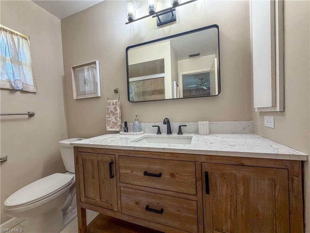 Bathroom featuring vanity and toilet