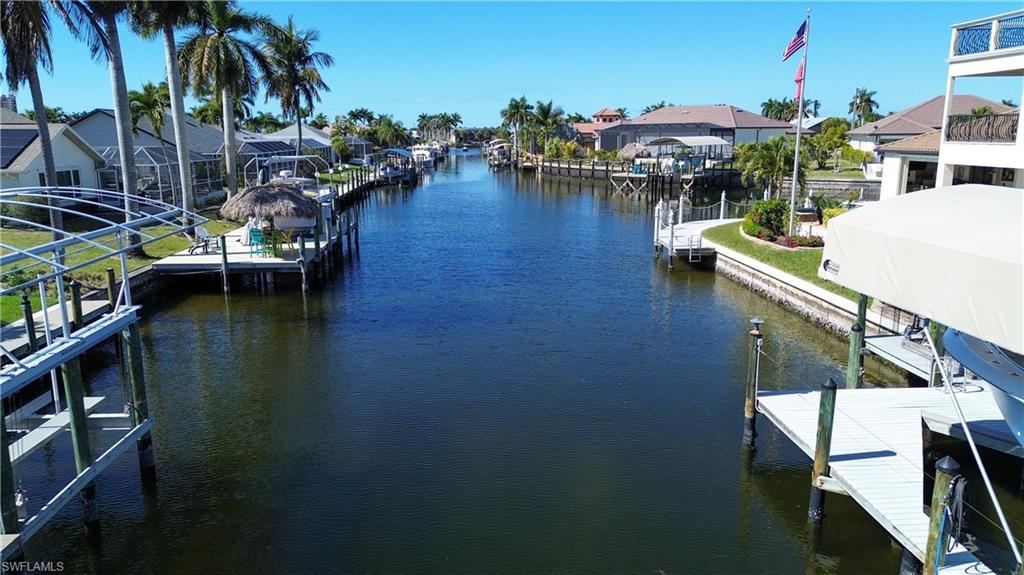 Dock area with a water view and a residential view