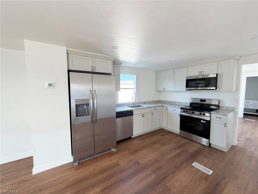 Completely updated with new cabinetry, granite countertops, brand-new appliances, and modern fixtures, this kitchen is both stylish and functional.
