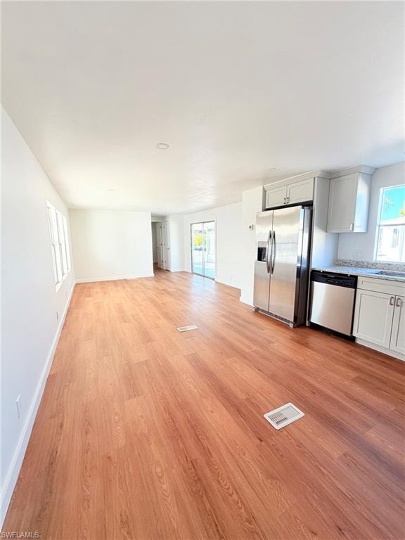 Bright and inviting with new LVT flooring and fresh finishes, the living room offers a comfortable space to relax or entertain.