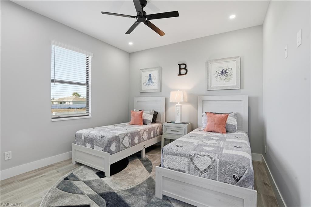 Bedroom featuring wood finished floors, ceiling fan, and recessed lighting