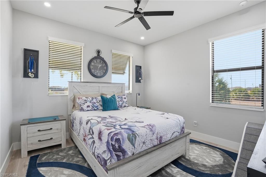 Bedroom featuring ceiling fan, recessed lighting, and wood finished floors