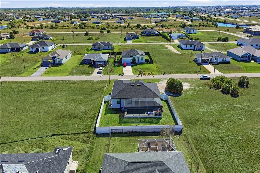 Aerial view of residential area featuring a large body of water