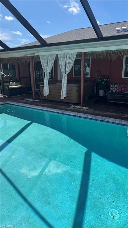 Outdoor pool with glass enclosure and an outdoor hangout area