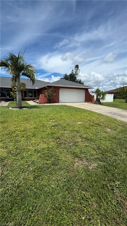 Ranch-style home featuring a front lawn, concrete driveway, a garage, and a shingled roof