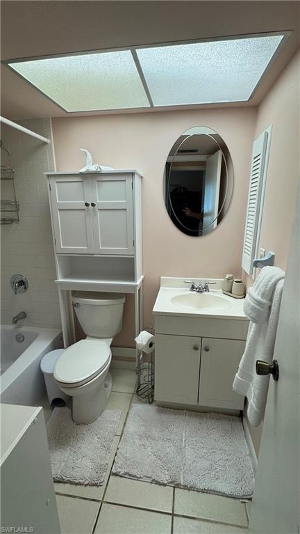 Full bath with vanity, washtub / shower combination, and light tile patterned floors