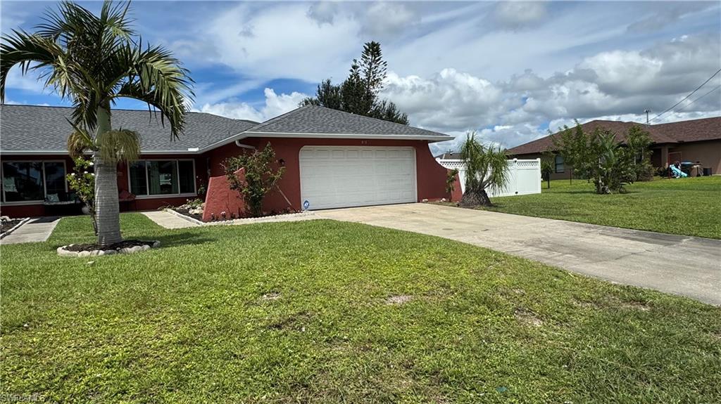 Ranch-style house with driveway, roof with shingles, a garage, and stucco siding