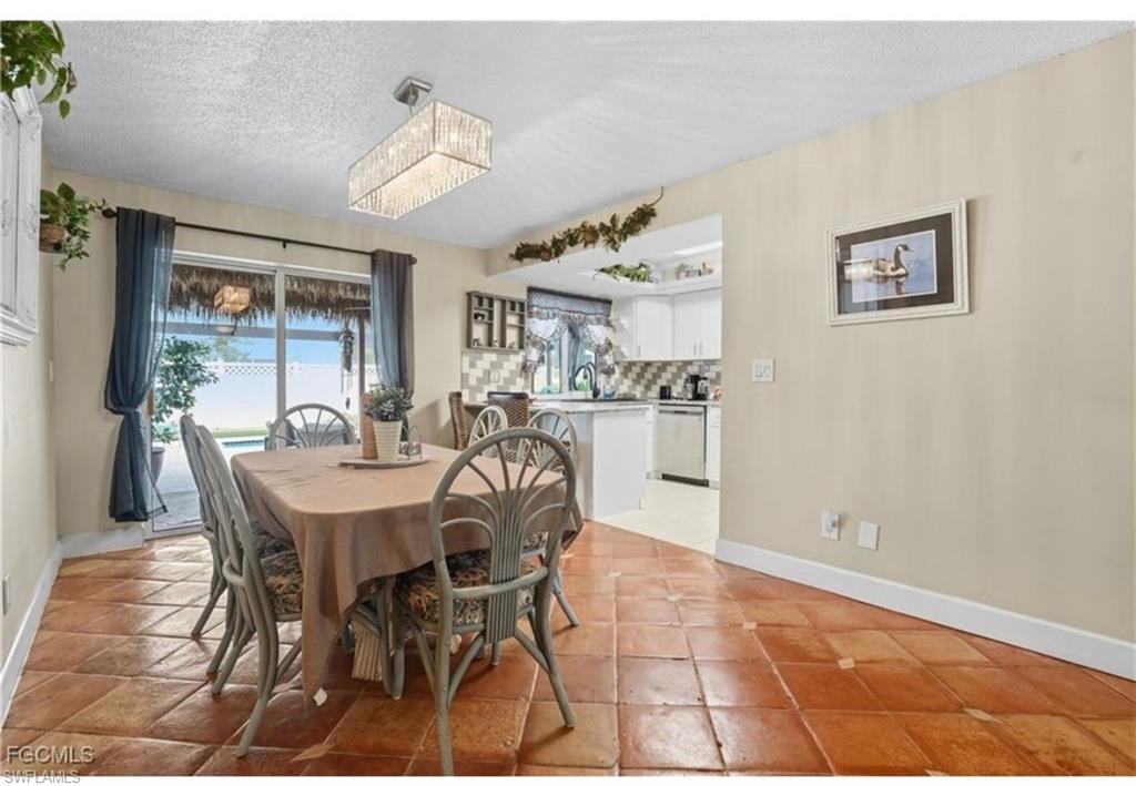 Dining room with a textured ceiling and baseboards