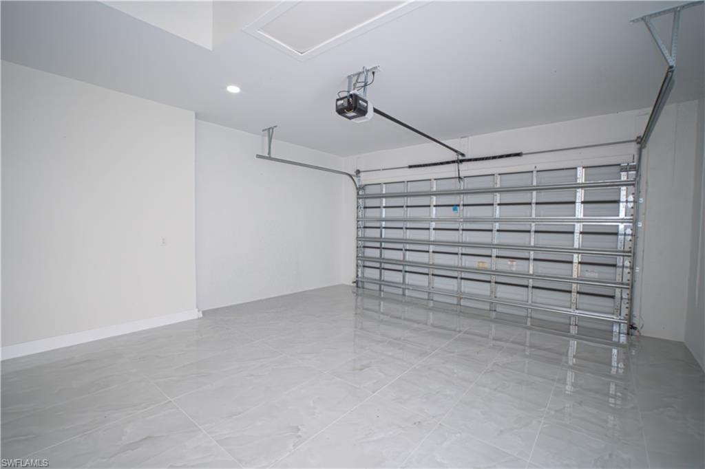Garage with recessed lighting and a garage door opener