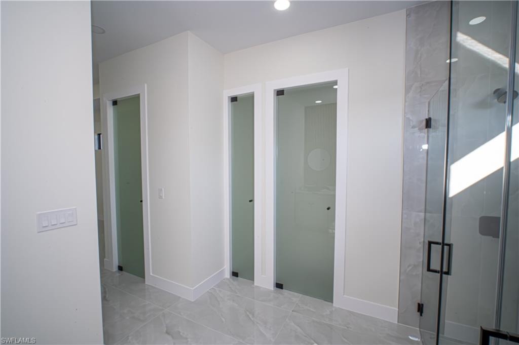 Bathroom featuring a stall shower and recessed lighting