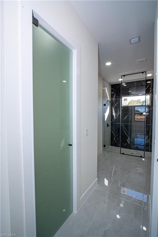 Corridor with recessed lighting and marble finish floors