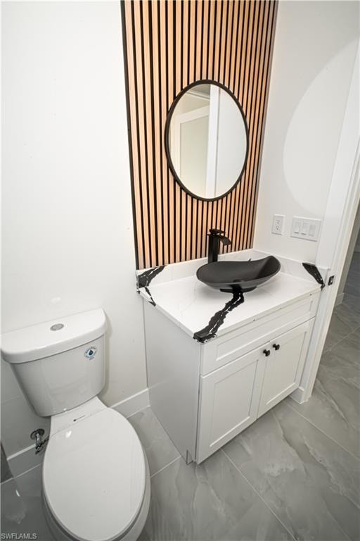 Bathroom with vanity and wallpapered walls