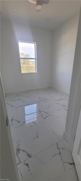 Unfurnished room featuring marble finish floors
