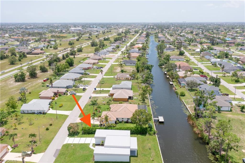 Aerial overview of property's location with nearby suburban area and a large body of water