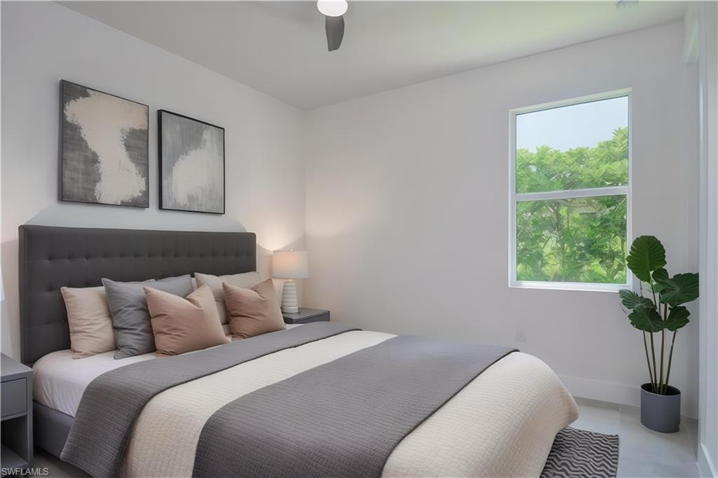 Bedroom with a ceiling fan and baseboards