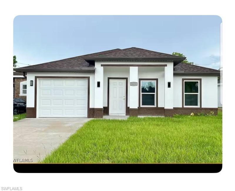 Prairie-style house with a garage and a front lawn