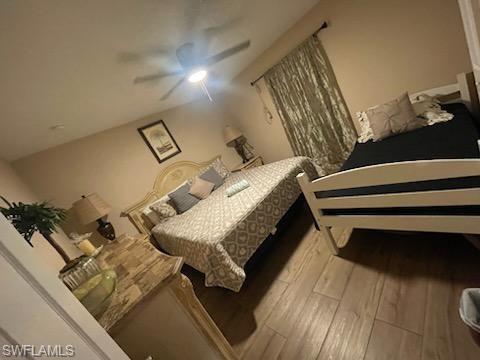 Bedroom featuring lofted ceiling, ceiling fan, and light hardwood / wood-style floors