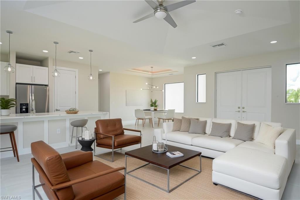 Living room featuring recessed lighting, plenty of natural light, and a ceiling fan