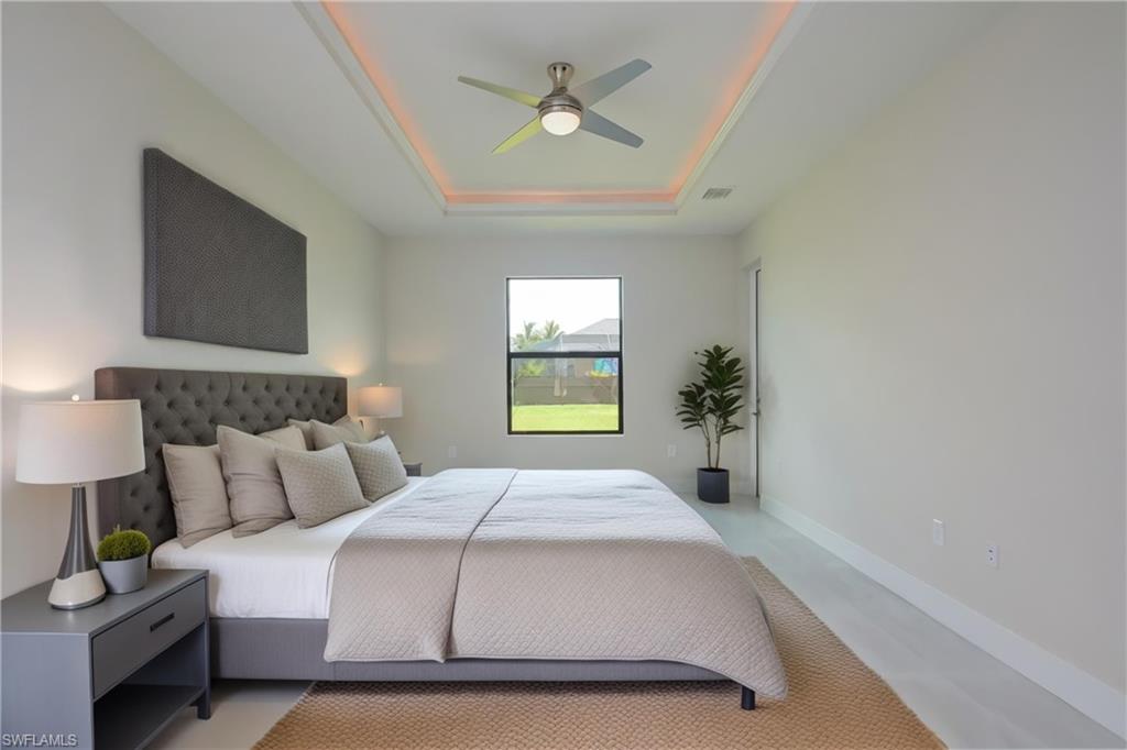 Bedroom featuring ceiling fan and a raised ceiling