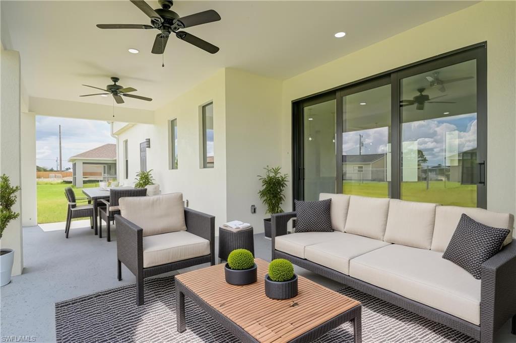 View of patio / terrace featuring a ceiling fan and an outdoor living / dining area