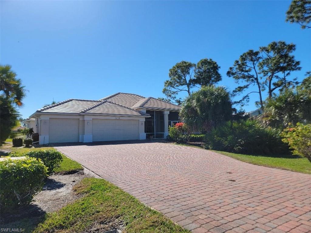Single story home with a 3 car garage, long pavered driveway, cbs construction, two screened patios and new tiled roof