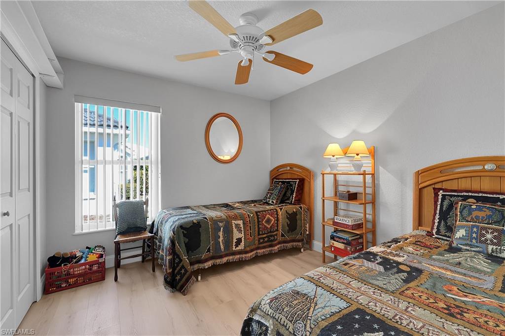 2nd Bedroom featuring a closet, new LVP light wood plank look floors, and ceiling fan