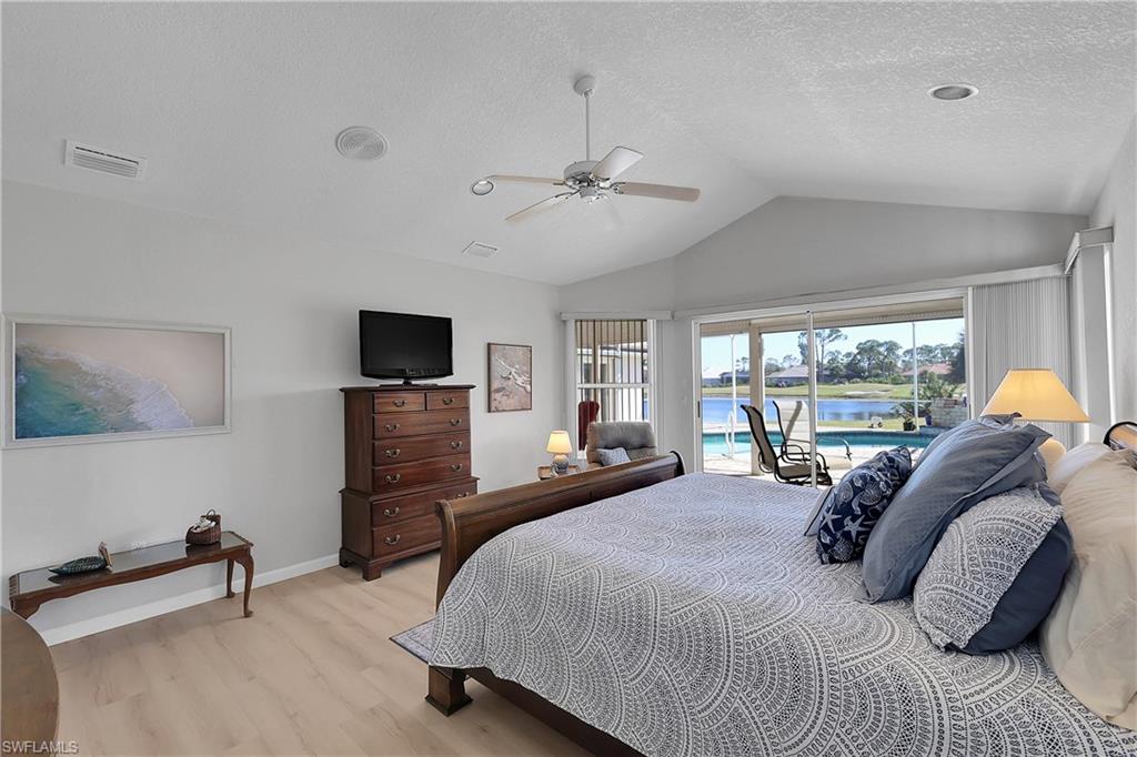 Primary bedroom includes a large walk-in closet. Textured walls and ceiling throughout
