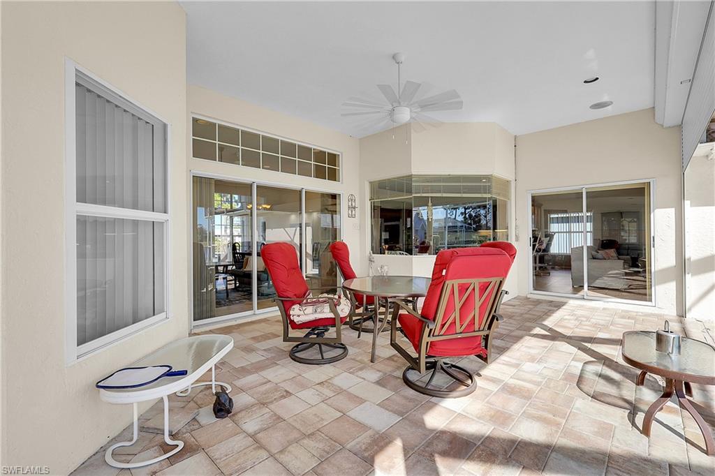 View of spacious covered patio featuring outdoor dining spaces, new ceiling fan and bay window to breakfast area. Patio has electric rolldown shutters, the rest of the home has accordian shutters and a few panel shutters for access.