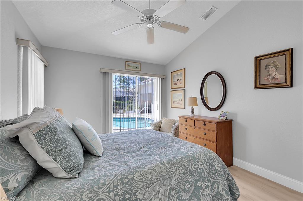 4th Bedroom featuring vaulted ceiling, access to pool area, light wood-type flooring, and a ceiling fan