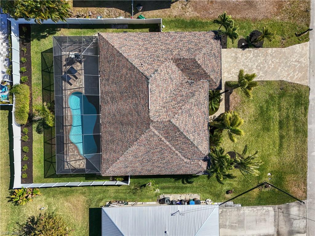 Aerial view of property and surrounding area featuring a pool area