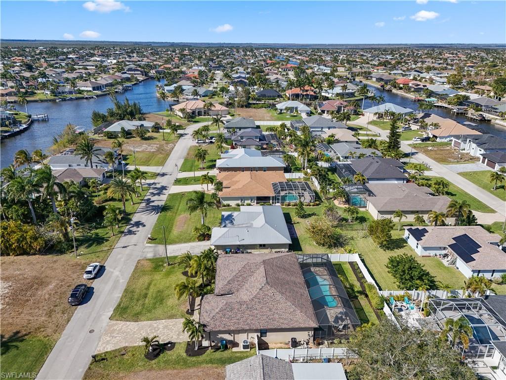 Aerial view of property's location featuring nearby suburban area and a nearby body of water