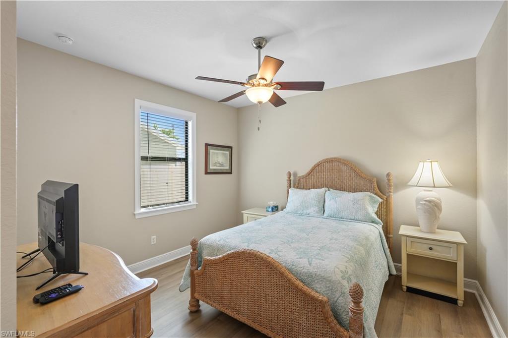 Bedroom with wood finished floors and ceiling fan