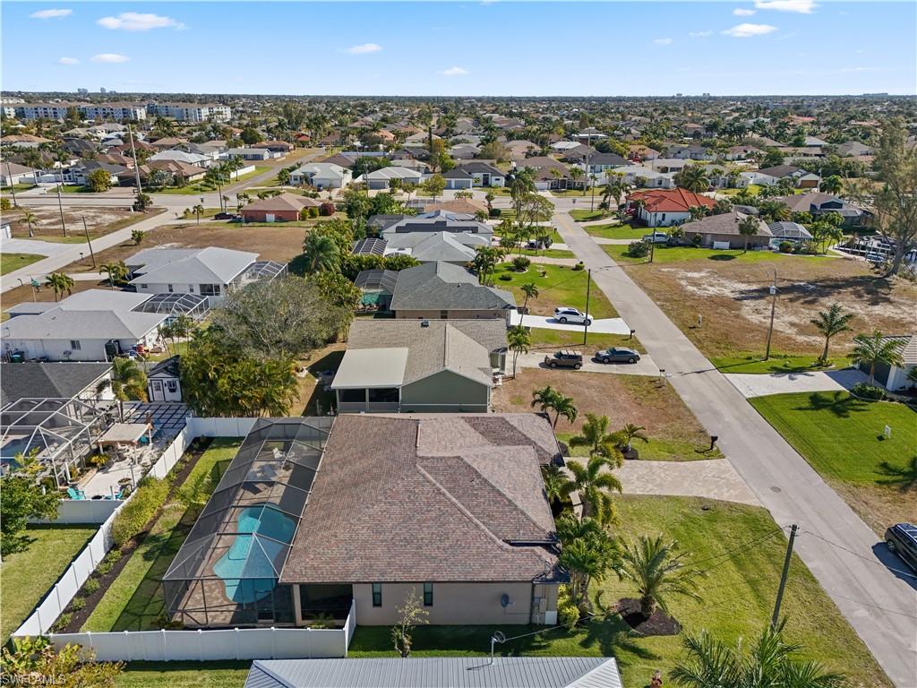 Aerial view of property and surrounding area with nearby suburban area