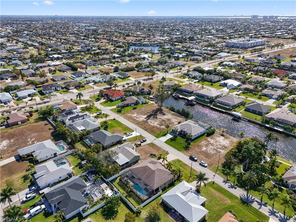 Aerial view of property's location with nearby suburban area and a nearby body of water